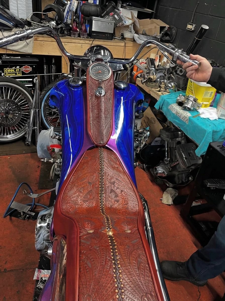 Custom motorcycle with hand-tooled brown leather seat and matching tank cover