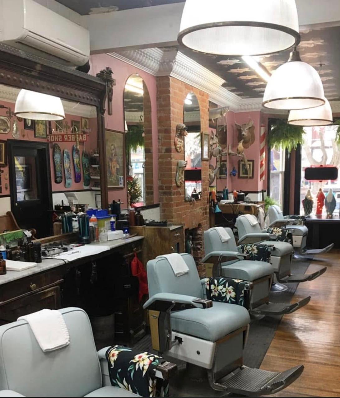 Row of upholstered barber chairs in a heritage barbershop